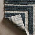Hagen rug corner flipped to reveal woven backing and edge stitching