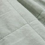 Detailed close-up of shore blue cotton fabric highlighting soft texture and quilted grid pattern