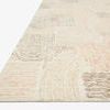 Close-up angled view showing low pile texture and stitched edge of Milo Peach Pebble wool rug