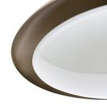 Bottom close-up focusing on milky glass diffuser with small brass finial at center