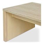 Close-up angled view of wood grain on table leg and textured beige stone surface