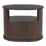 Styled bedroom scene with Tommy nightstand positioned beside bed with decor accents on top