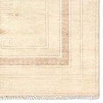 Close-up of rug's corner highlighting the medallion pattern and woven texture