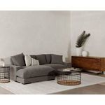 Dark grey Plunge sectional shown in a living room setting with wood sideboard and decorative vases