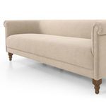 Angled close-up of sofa's front and side, showcasing welt cord trim and cushioned seat