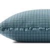 Side view of ocean blue pillow showing ruffled edge detail and thickness