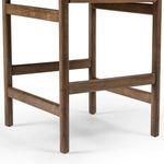 Close-up of the lower wooden frame and footrest in solid parawood with natural grain
