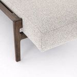 Close-up of bench corner showing upholstery fabric wrapping and wooden leg connection