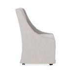 Side profile highlighting the curved armrest and smooth upholstery of the dining chair