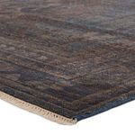 Close-up angled view showing low pile texture and detailed abrashed color variations in blue and brown