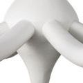 Close-up on bottom central point of chandelier, showing tapered textured white iron base and curved arms