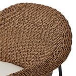 Close-up of woven rounded back with woven pattern and black iron legs below