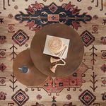 Corner close-up showing intricate floral and geometric motifs with contrasting dark blue border