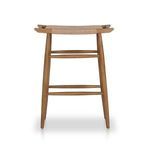 Front view showcasing tapered teak legs and stacked stretchers with wicker seating