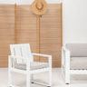 Newport Dining Chair styled beside matching outdoor sofa and wooden privacy screen with hat