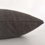 Side view of graphite gray pillow showcasing seam and textured fabric detail
