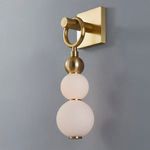 Perrin wall sconce illuminated showing warm glow on frosted globes