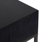 Close-up of right corner edge of console table showing black wood finish and grain texture