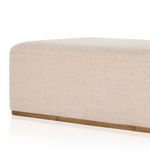 Overhead view focusing on rounded top corner and fabric texture of ottoman