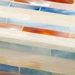 Close-up of mother of pearl mosaic strips showing textured, multi-tonal iridescent surface