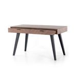 Side view of desk with right drawer partially open revealing storage