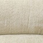 Detailed close-up of plush cream fabric emphasizing its looped, textured weave
