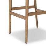 Close-up of bottom leg end with protective glider on wooden bar stool frame