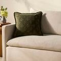Darla Olive Pillow styled on beige corduroy sofa with natural light and small side table with flowers