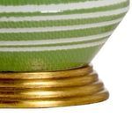 Close-up detail of the gold leaf base showing texture and paint finish