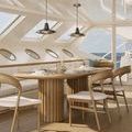 Wide view of two pendants installed with adjustable rods in a well-lit yacht dining space