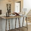 Kirkwood Console Table shown in a living room behind a sofa with decorative objects on top
