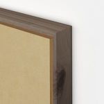 Close-up of raw canvas edge and vertical grain walnut frame showing natural wood texture and corner detail