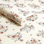 Rolled wallpaper with visible texture showing floral and butterfly pattern on cream background