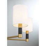 Conrad 5-light chandelier with warm brass finish, white fabric shades, and black marble accents on arms and center column