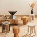 Multiple end tables and stools, including Leland End Table, arranged in a showroom environment