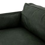 Close-up from front corner focusing on tapered almond-finished wooden leg