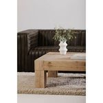 Side view of coffee table showing reclaimed oak texture with decorative vase and books