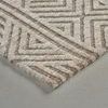 Close-up of corner showing rug’s plush texture and detailed geometric pattern in tan and beige