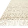 Close-up of one fringed edge showing thick twisted yarn and woven geometric texture