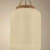 Side view of illuminated Judson Lantern pendant showing warm glow and detailed rattan wrapping near top