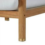 Close-up of teak leg with brass foot cap highlighting construction and finish