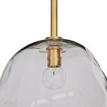 Close-up detail of brass socket and clear bulb inside smoke glass pendant