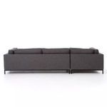 Back view of Grammercy sectional revealing plain fabric back and black iron legs