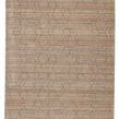 Rectangular rug in tan, gray, and taupe with distressed geometric lattice pattern and metallic accents