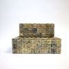 Two decorative bone boxes stacked in an offset position for visual depth