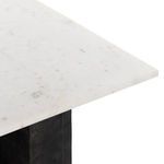 Detail of marble top meeting angular black legs of the Terrell End Table