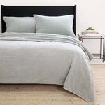 Queen-sized Amsterdam Coverlet in shore blue with soft cotton fabric and subtle grid quilting on bed