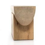 Angled side view emphasizing rounded beam top supported by solid block base