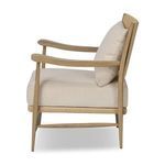 Side profile of Godfrey Chair highlighting oak frame and beige fabric cushions