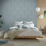 Palais Wallpaper shown as accent wall behind bed in a staged modern bedroom setting
